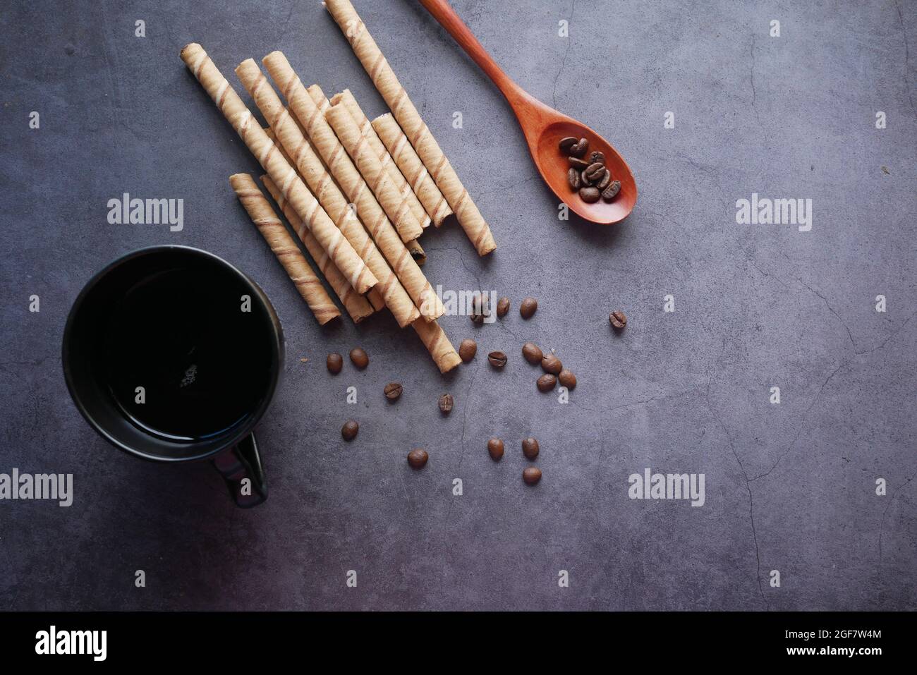 wafer roll chocolate, coffee beans and coffee on black  Stock Photo