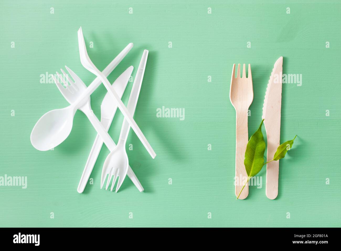 harmful plastic and eco friendly wooden cutlery. plastic free concept