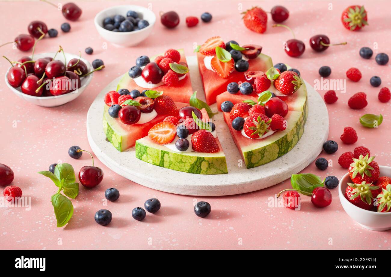 watermelon pizza slices with yogurt and berries, summer dessert Stock Photo