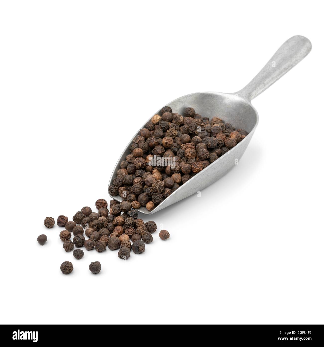 Metal scoop with dried black pepper seeds isolated on white background Stock Photo