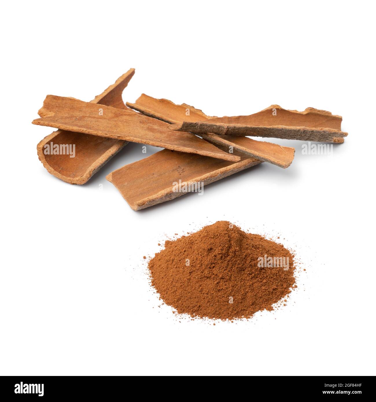Dried Cinnamon bark and a heap of ground cinnamon powder isolated on white background Stock Photo