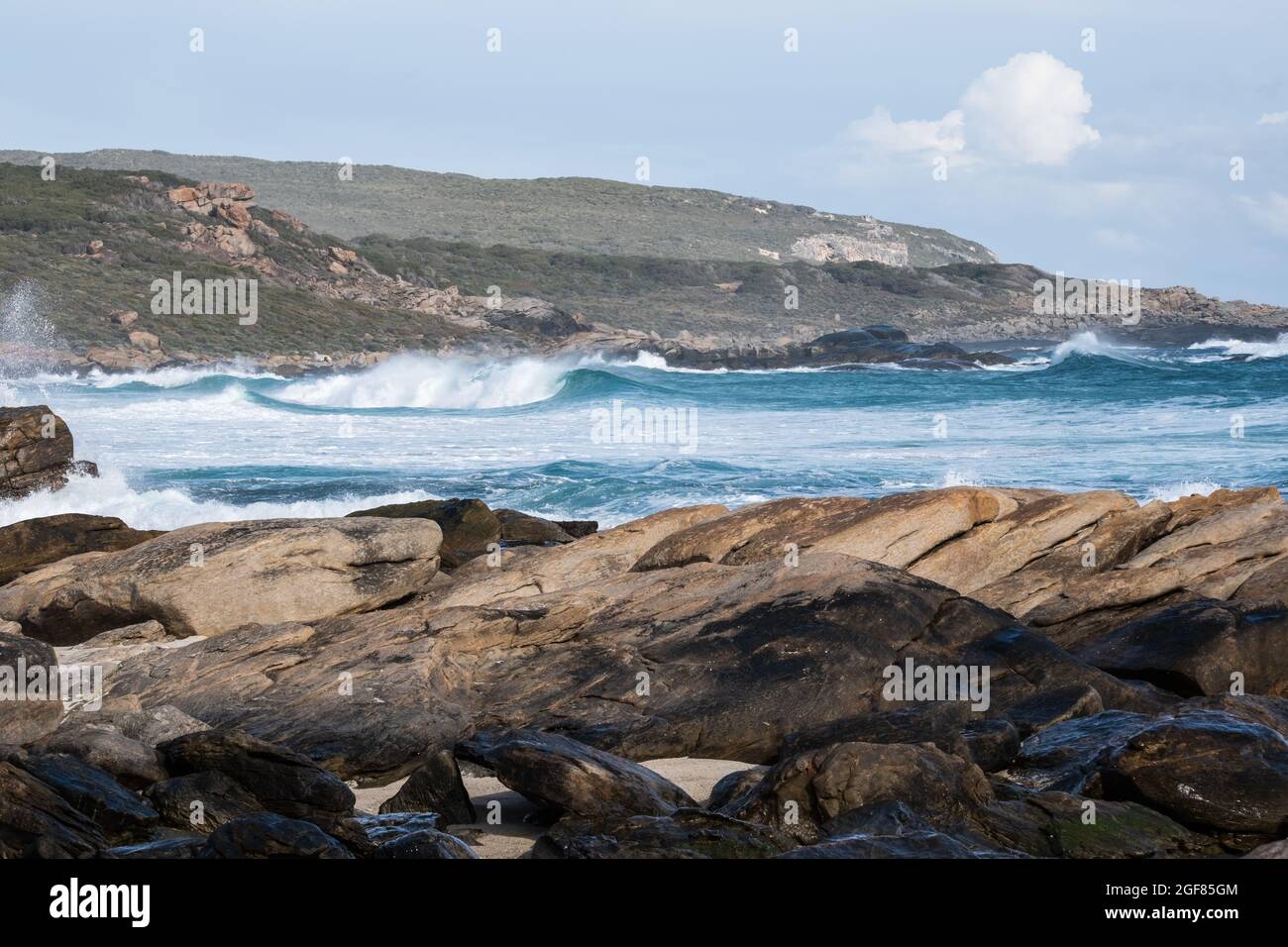 Looking south over rocks to waves at Redgate Surf break, Calgardup Bay, Redgate, Western Australia Stock Photo