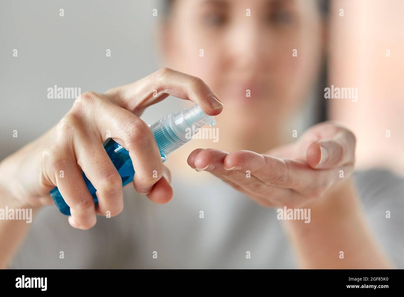 close up of woman spraying hand sanitizer Stock Photo - Alamy