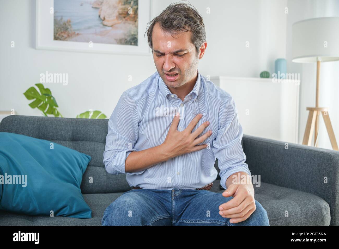 Man suffering chest pain at home and feeling bad Stock Photo Alamy