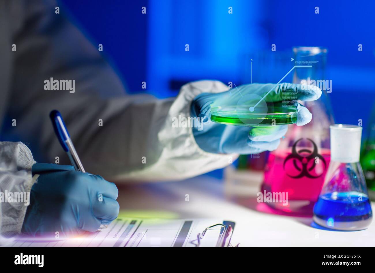 scientist with tests writing report of biohazard Stock Photo - Alamy