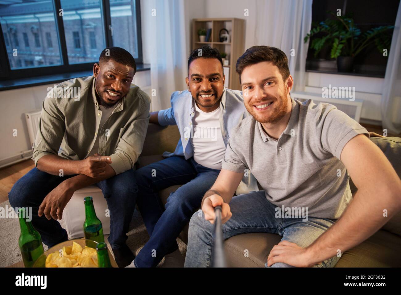 happy male friends taking selfie at home Stock Photo