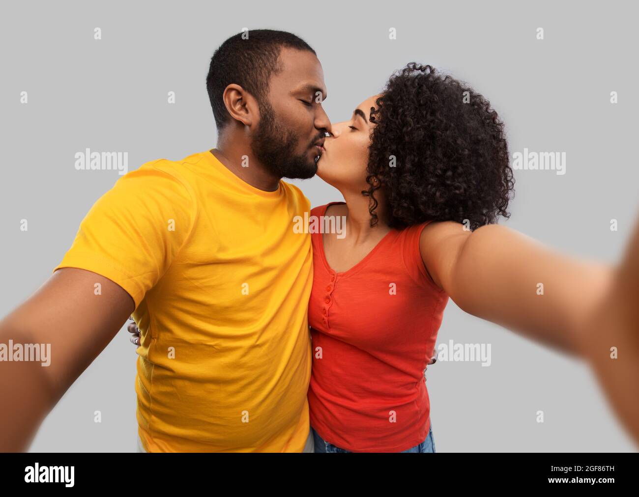 african american couple taking selfie and kissing Stock Photo