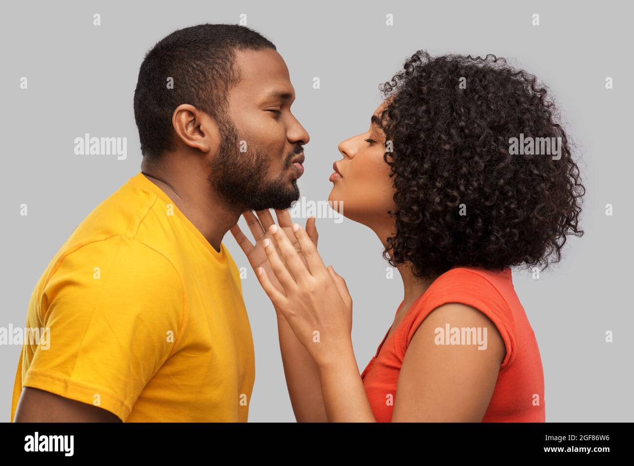 happy african american couple reaching for kiss Stock Photo