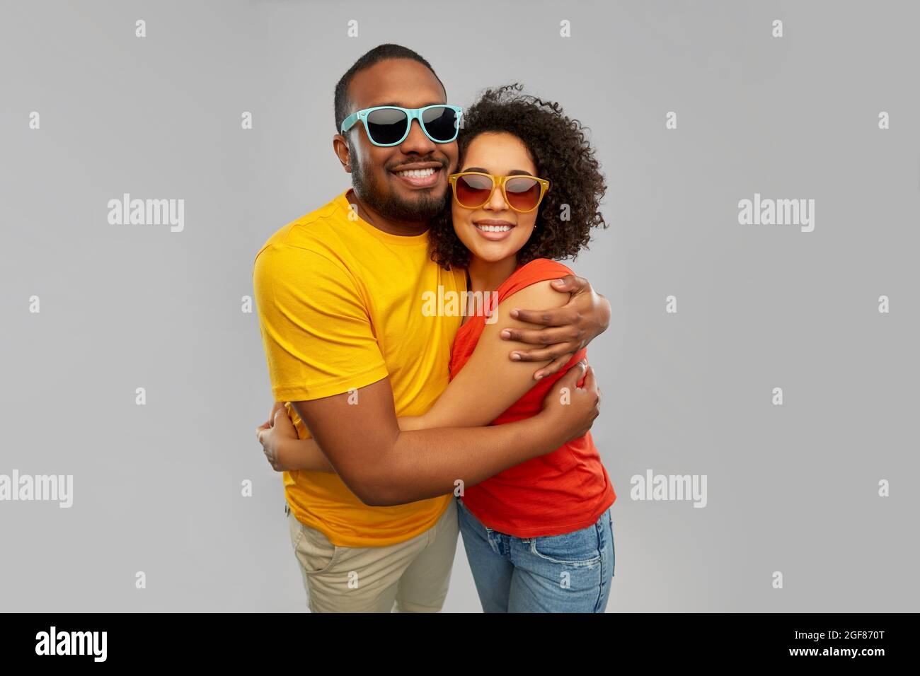 happy african couple in sunglasses hugging Stock Photo - Alamy
