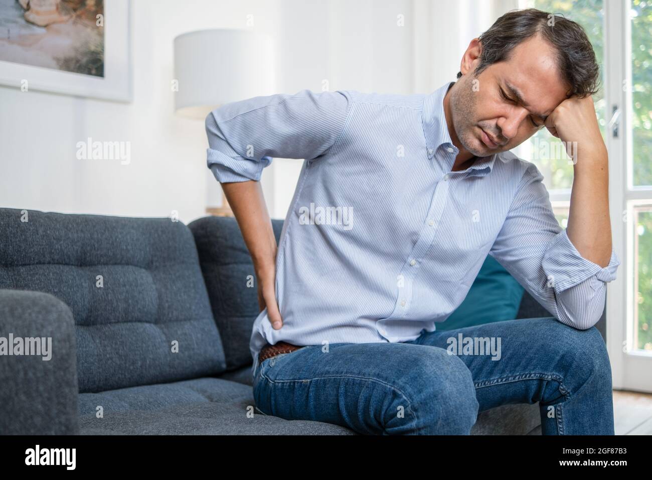 The masseur makes a relaxing massage of the trapezius muscles and back to  the client lying on the couch Stock Photo - Alamy