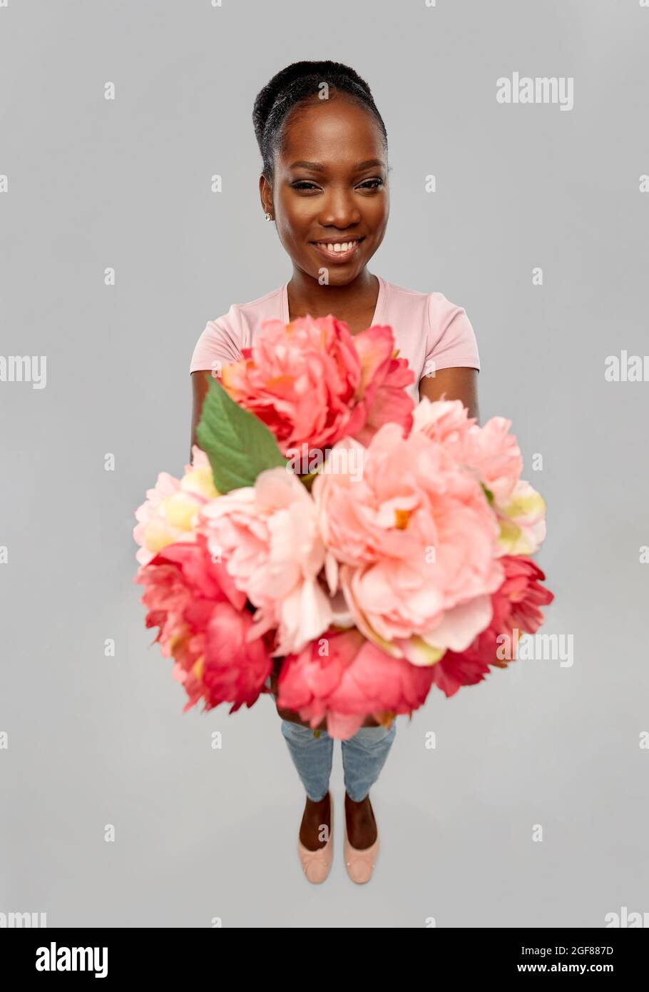 happy african american woman with bunch of flowers Stock Photo - Alamy