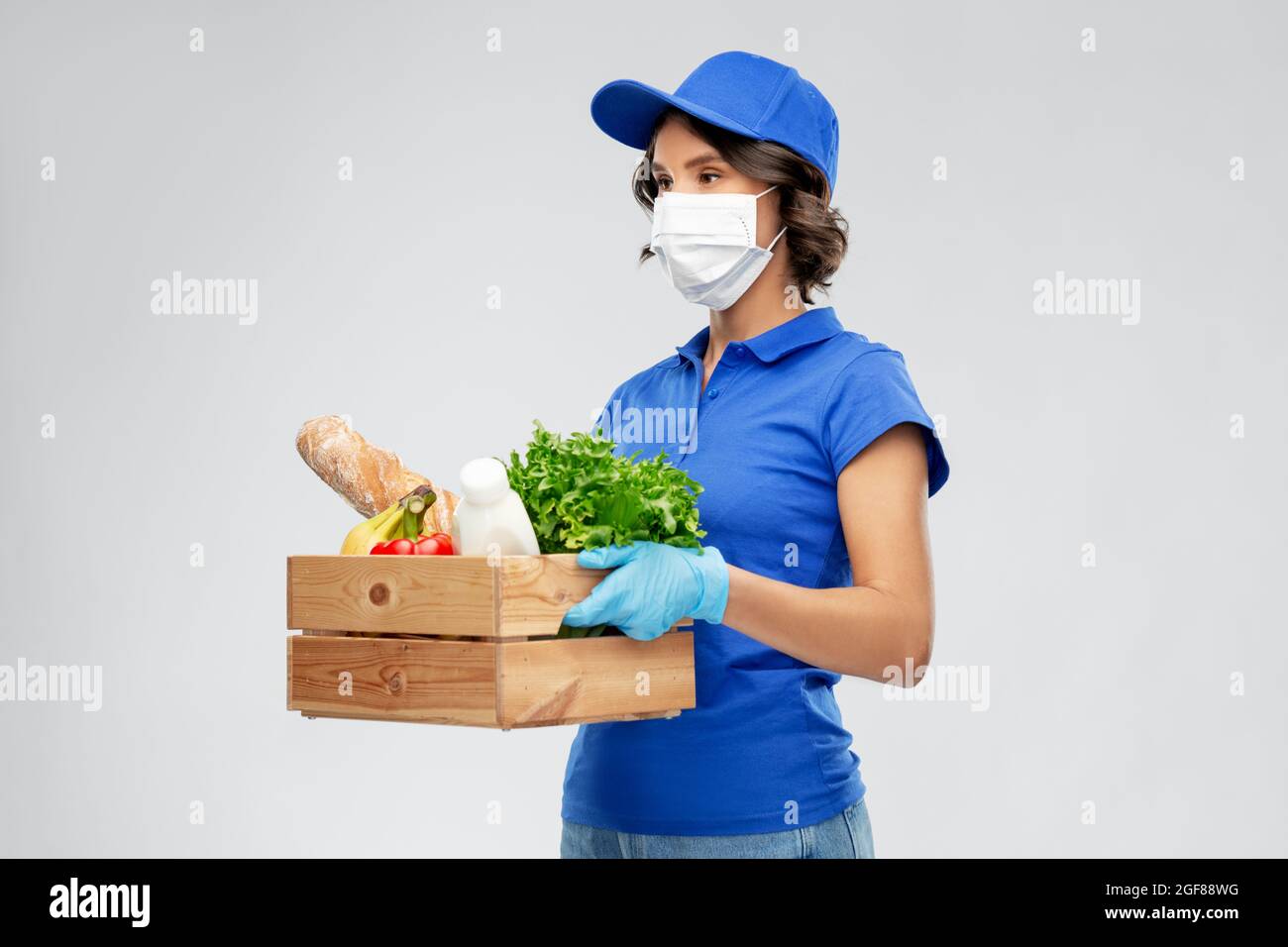 delivery woman in face mask with food in box Stock Photo - Alamy