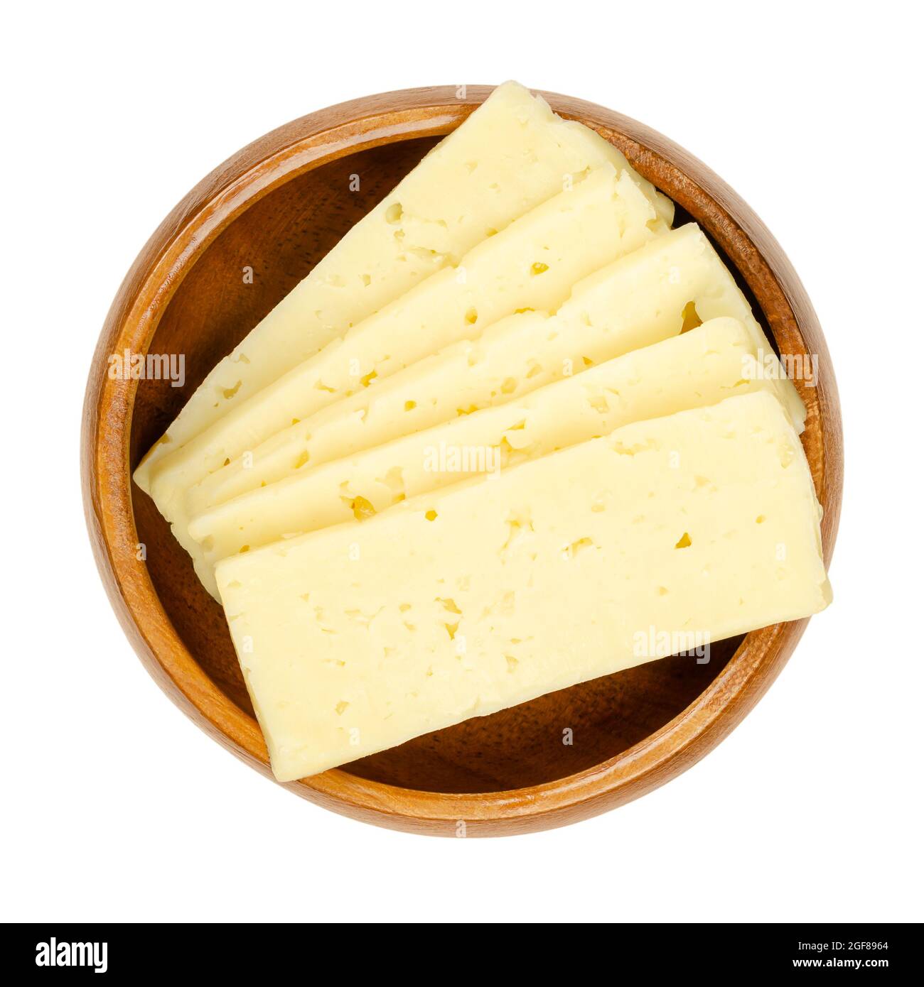 Tilsit cheese slices, in a wooden bowl. Sliced Tilsiter cheese, a pale yellow semi hard smear-ripened cheese, with a medium-firm texture. Stock Photo