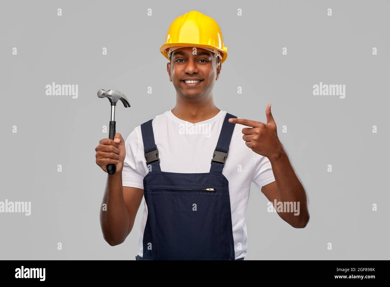 happy smiling indian worker or builder with hammer Stock Photo