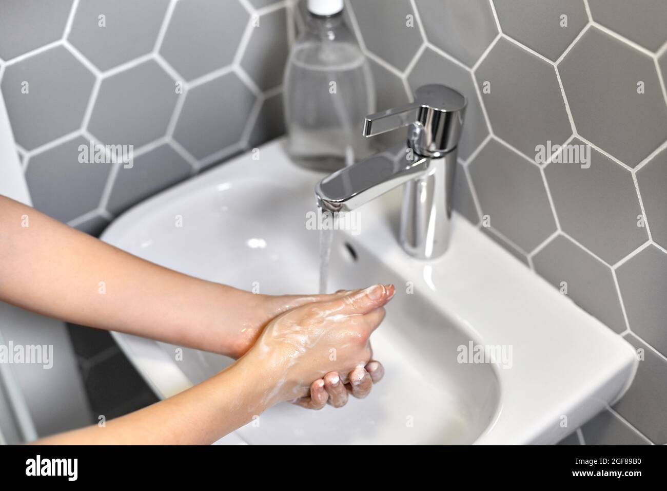 close up of woman washing hands with liquid soap Stock Photo