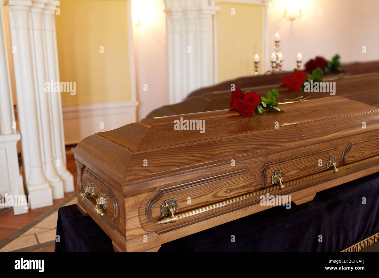 red rose flowers on wooden coffins in church Stock Photo Alamy
