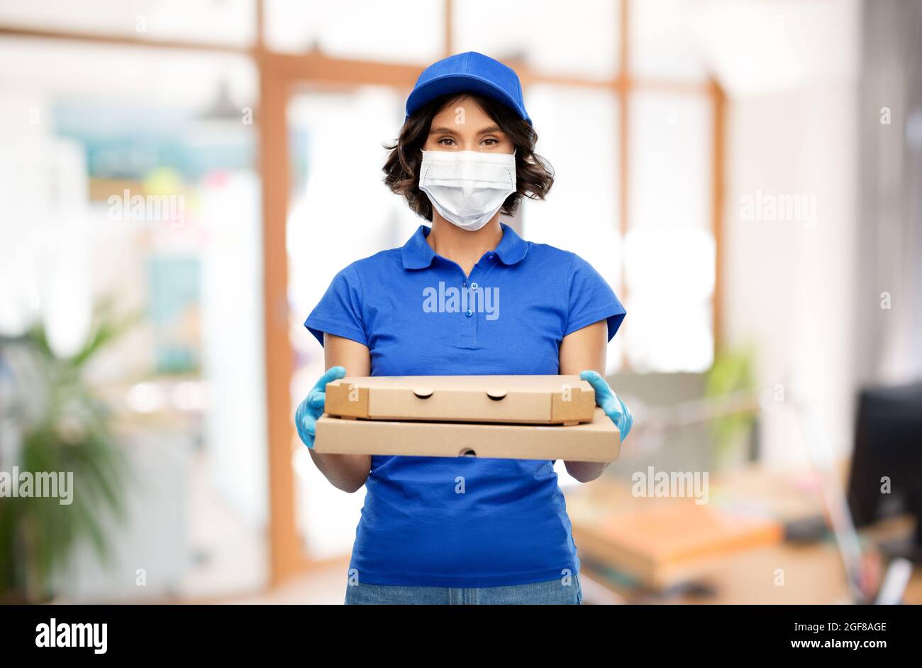 delivery woman in mask with pizza boxes at office Stock Photo - Alamy