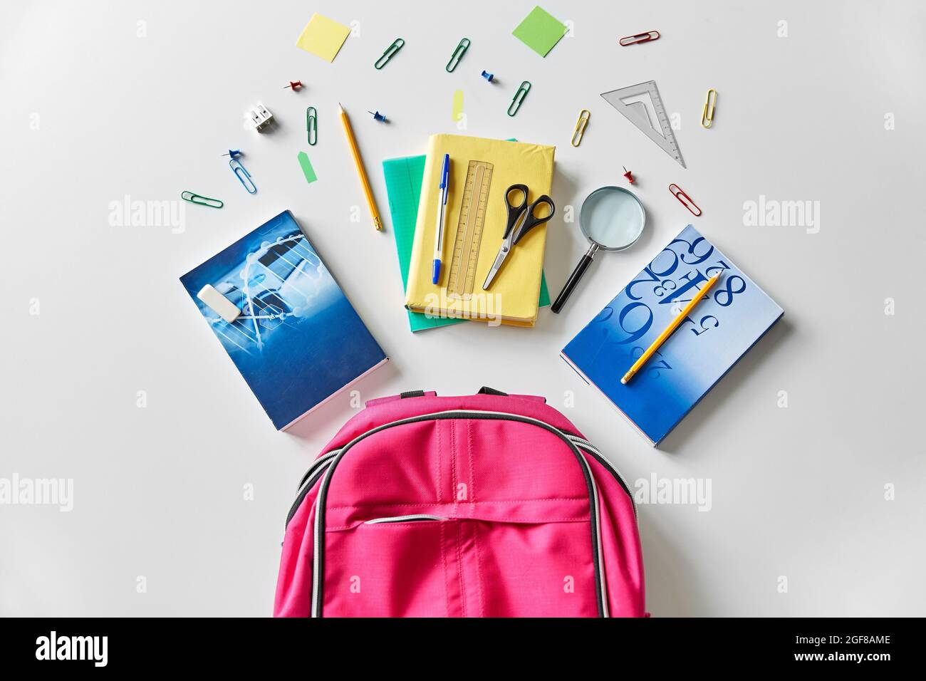 pink backpack with books and school supplies Stock Photo