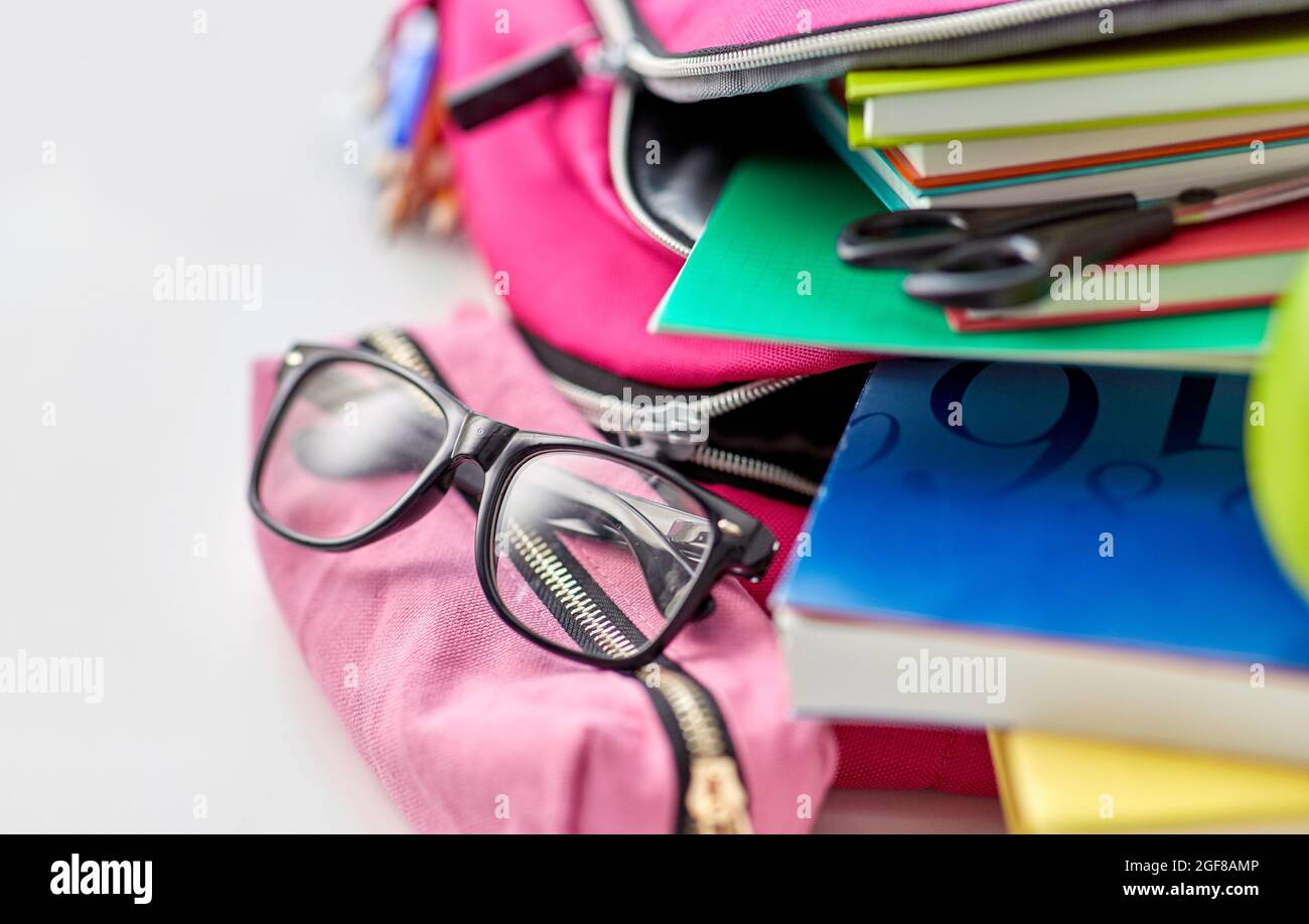 backpack, apple and school supplies on table Stock Photo