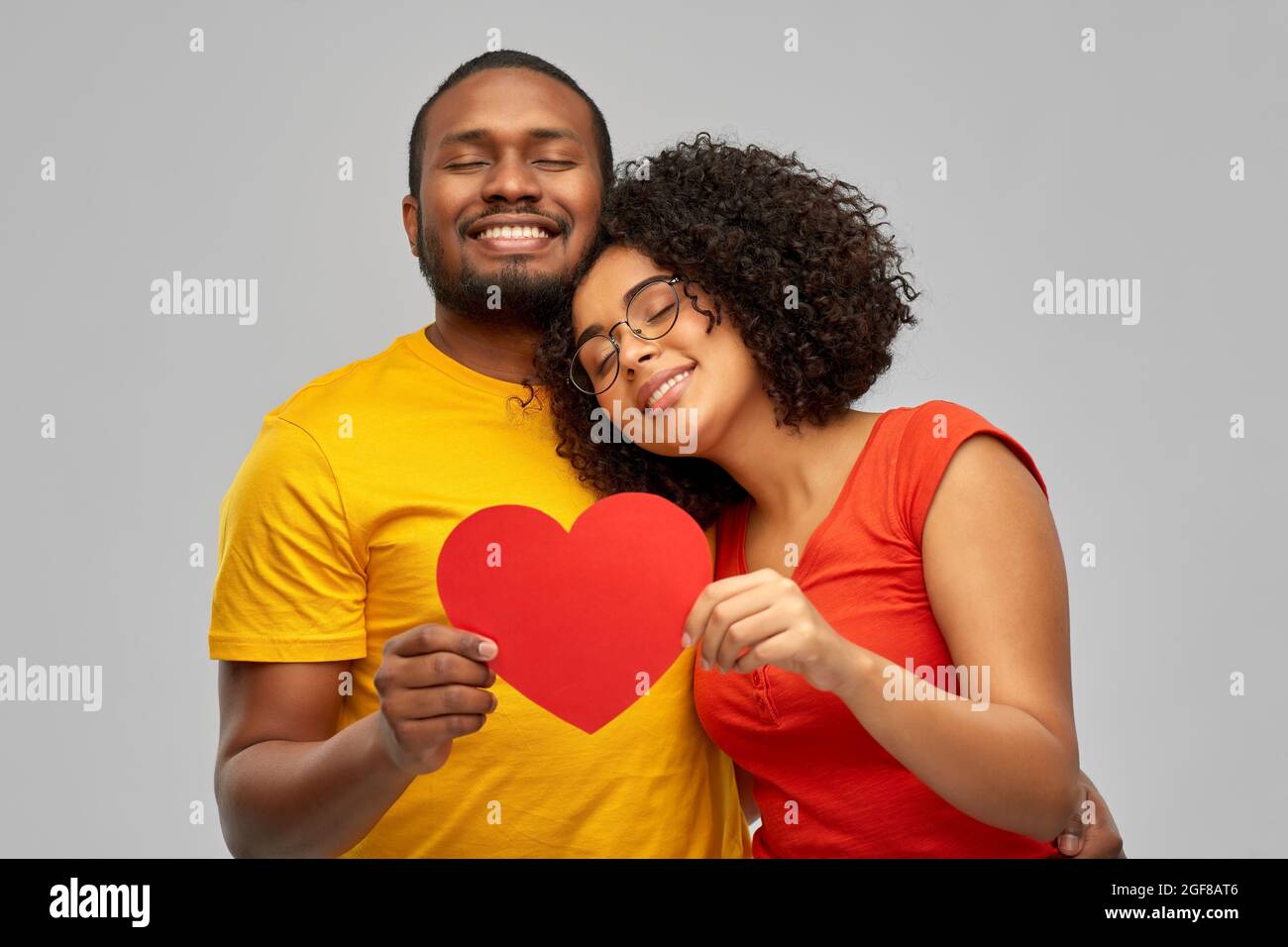 happy african american couple holding red heart Stock Photo - Alamy