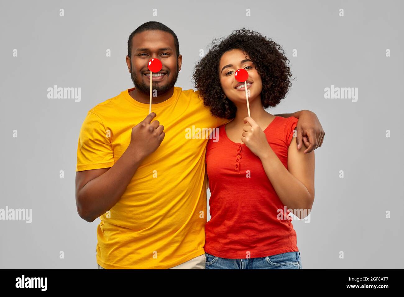 happy african american couple with red clawn noses Stock Photo