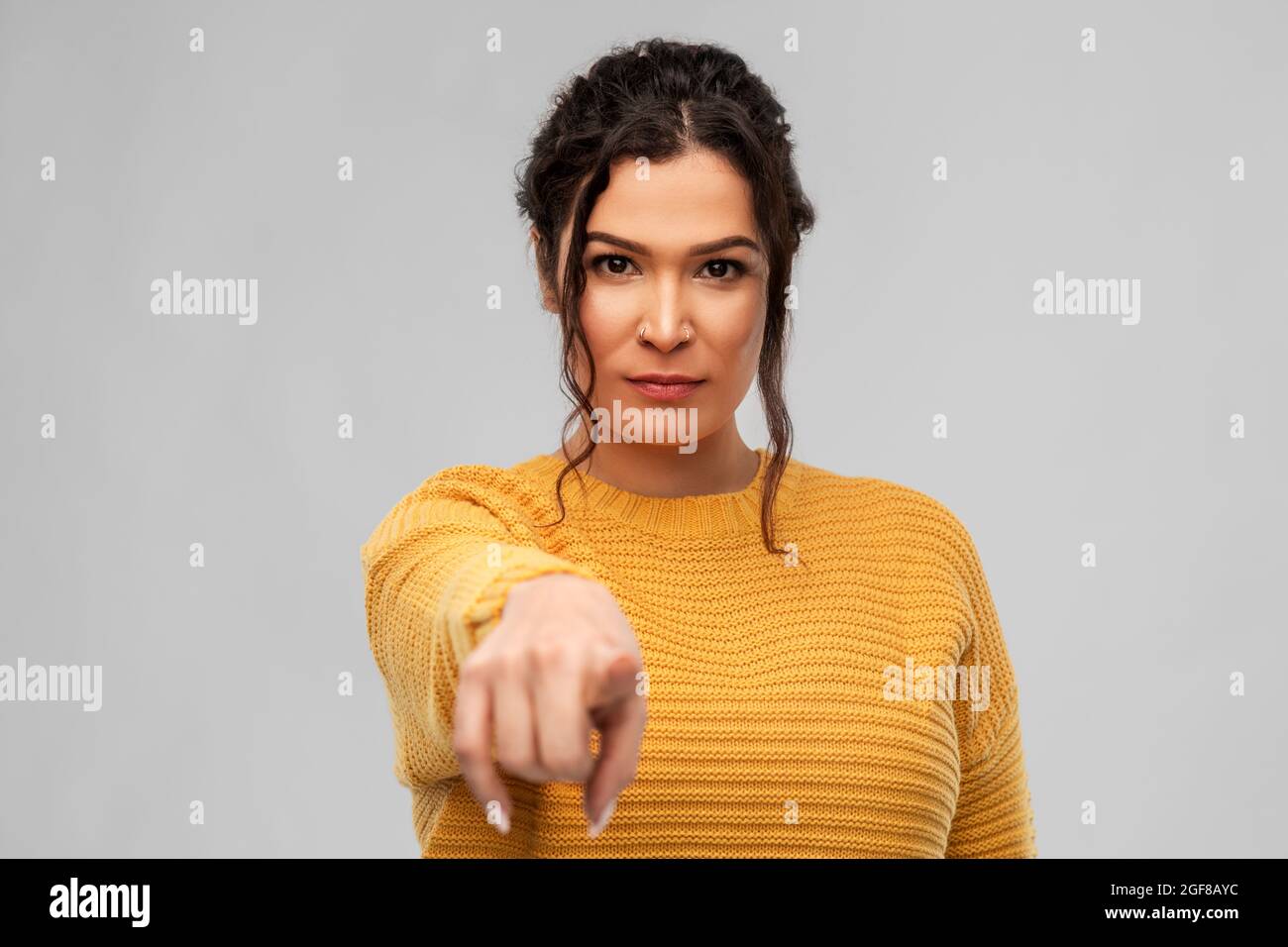 young woman pointing finger to camera Stock Photo