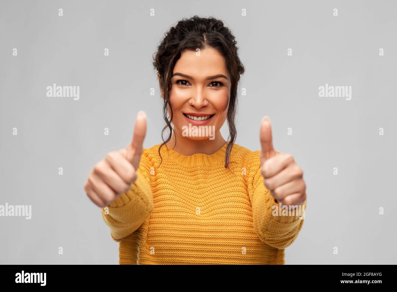 happy smiling young woman showing thumbs up Stock Photo