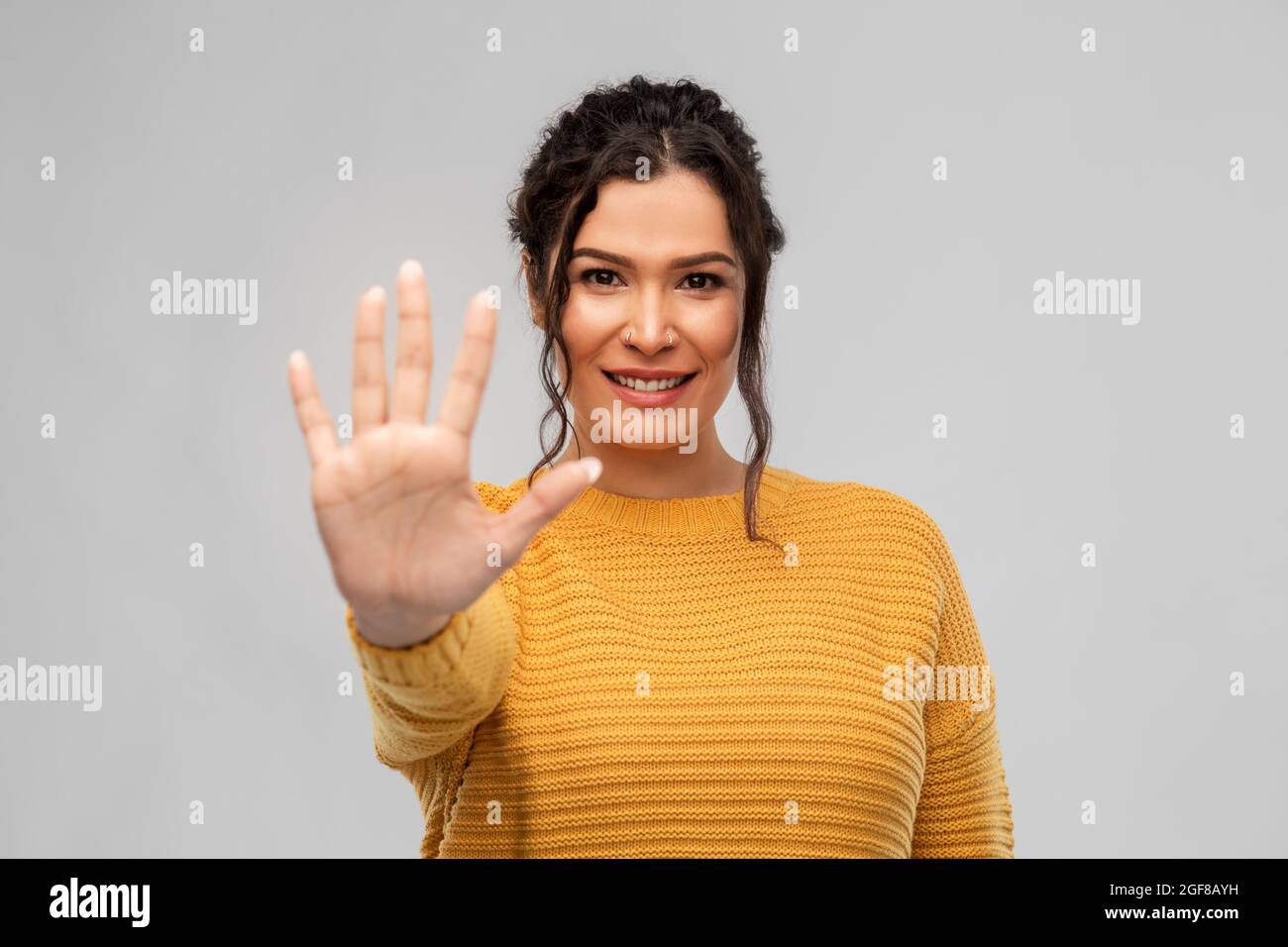 happy woman in pullover showing five fingers Stock Photo