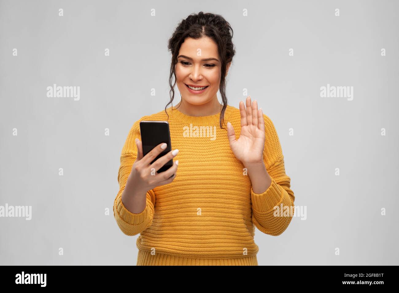 happy young woman having video call on smartphone Stock Photo