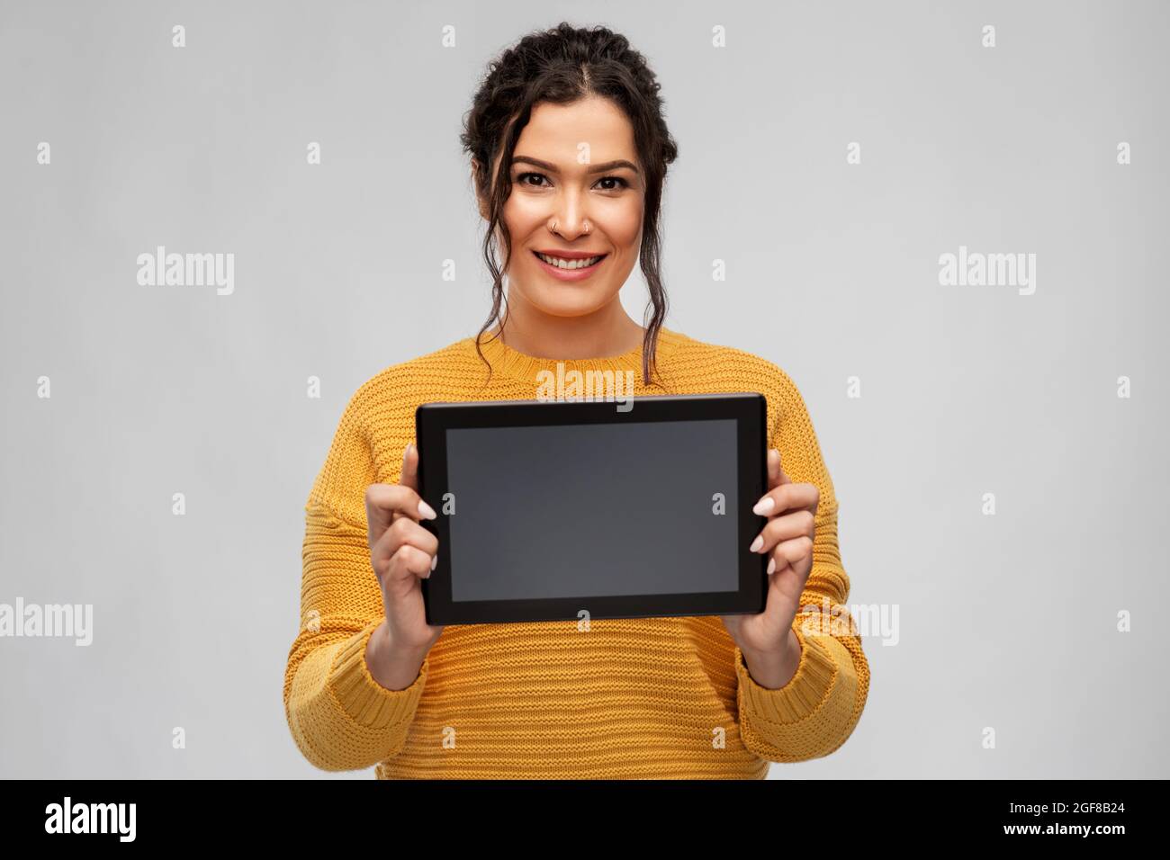 happy young woman showing tablet pc computer Stock Photo