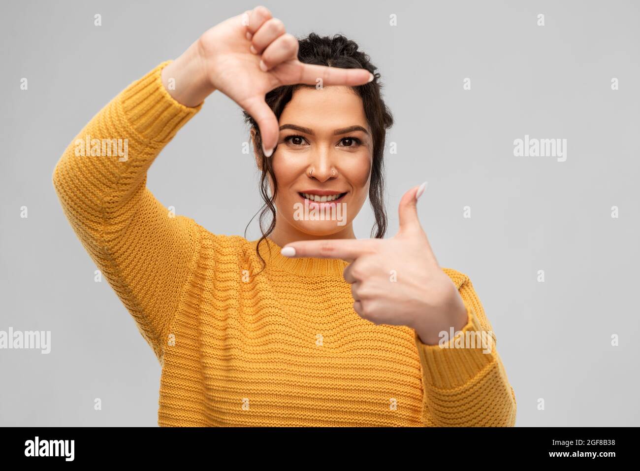 happy young woman making frame with her fingers Stock Photo