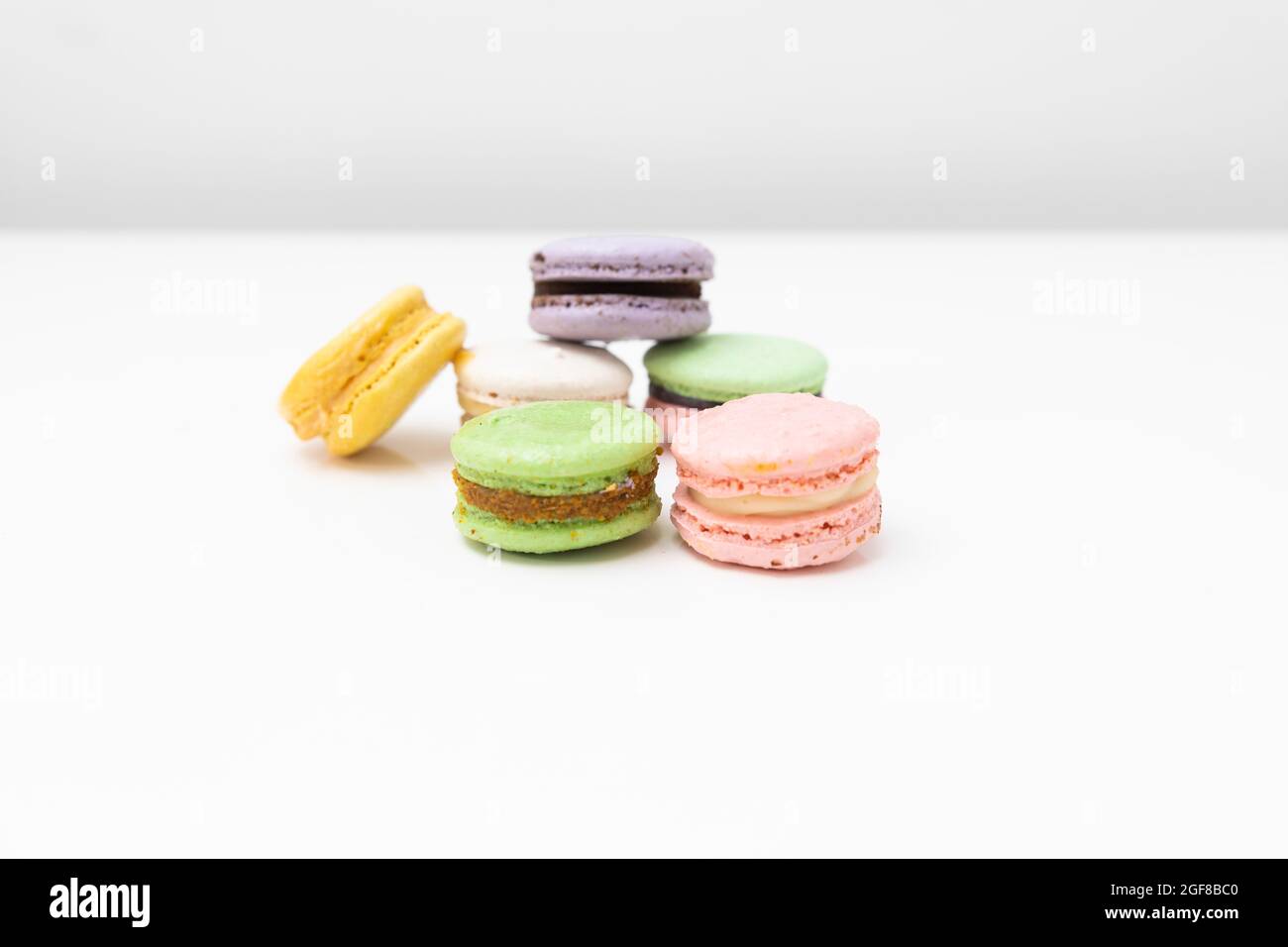 macaroons in different colours on a withe table Stock Photo
