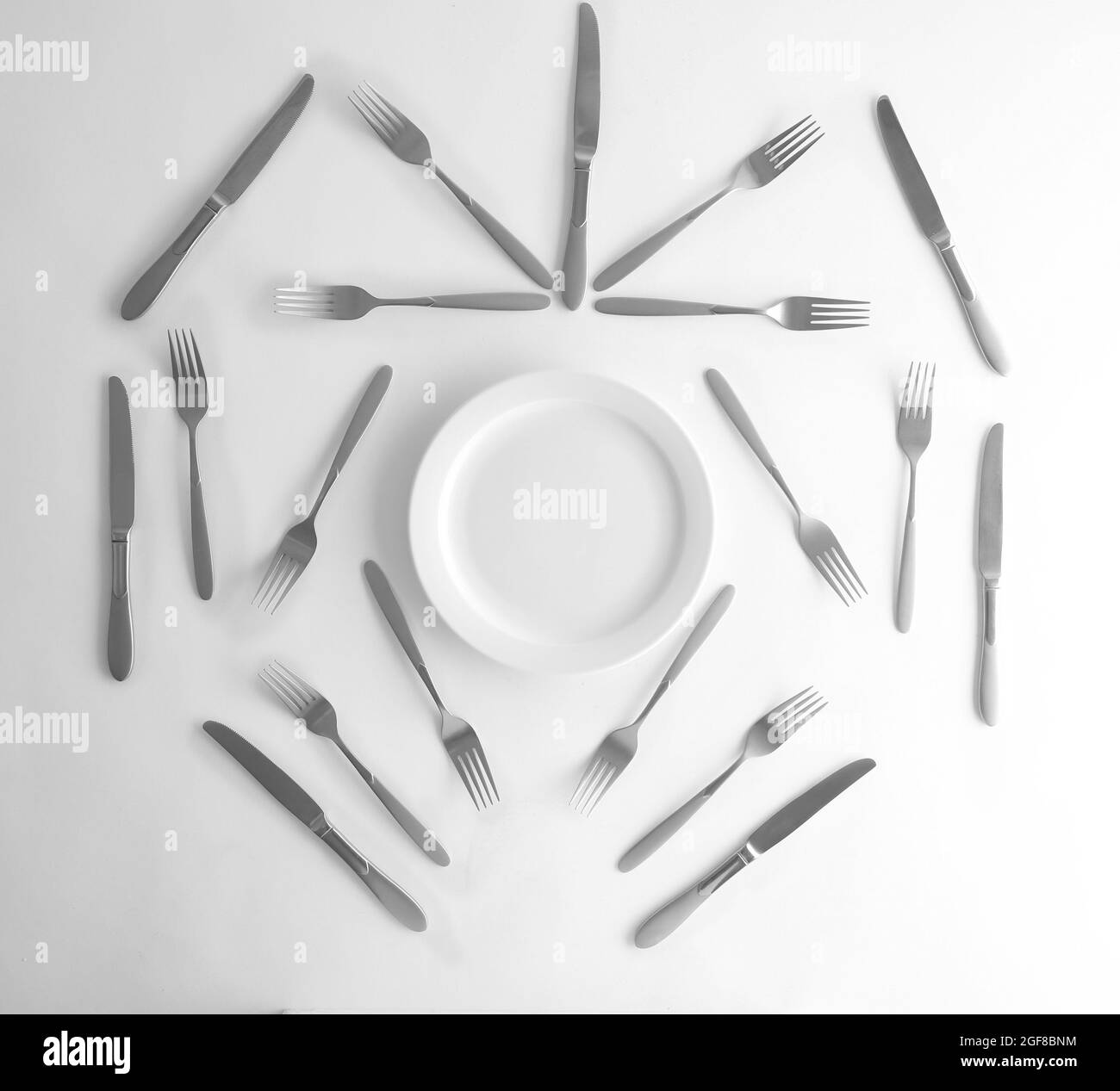 Plate, silver forks and knives, top view Stock Photo Alamy