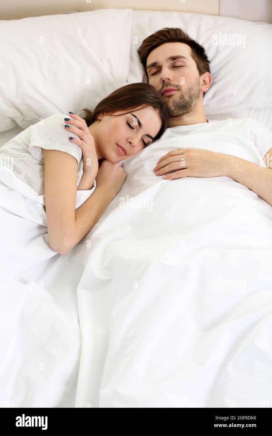 Young cute couple sleeping together in bed Stock Photo - Alamy