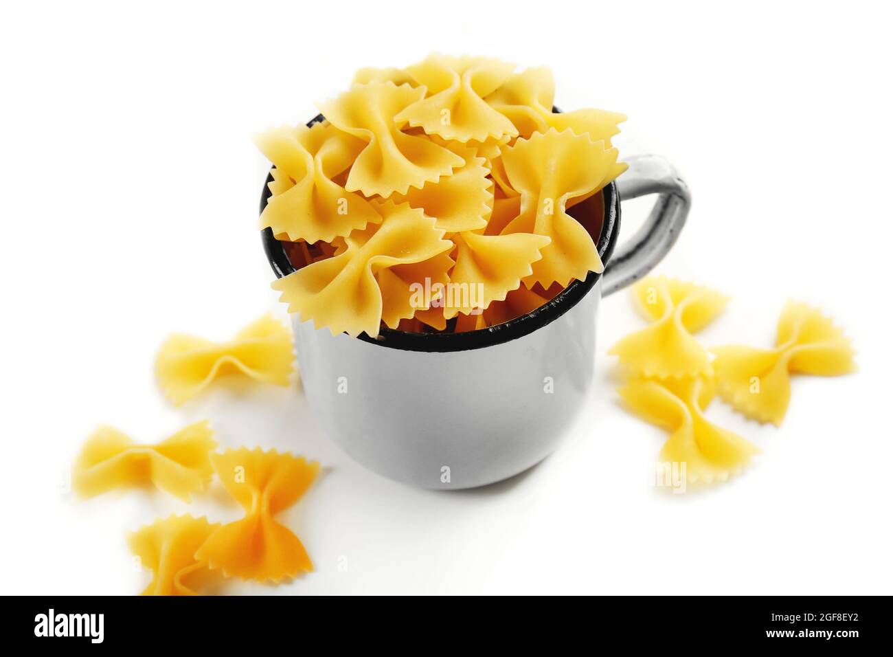 Pile of Italian dry pasta in a cup isolated on white Stock Photo Alamy