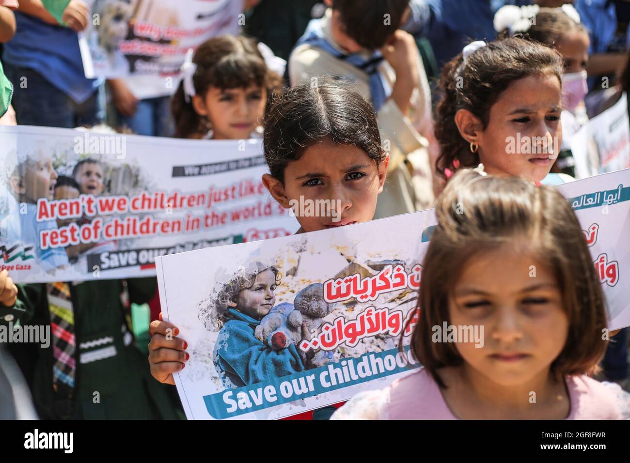 Gaza, Palestine. 24th Aug, 2021. Palestinian children hold banners during an event to send humanitarian messages to the world to end the siege of Gaza by Israel. Credit: SOPA Images Limited/Alamy Live News Stock Photo