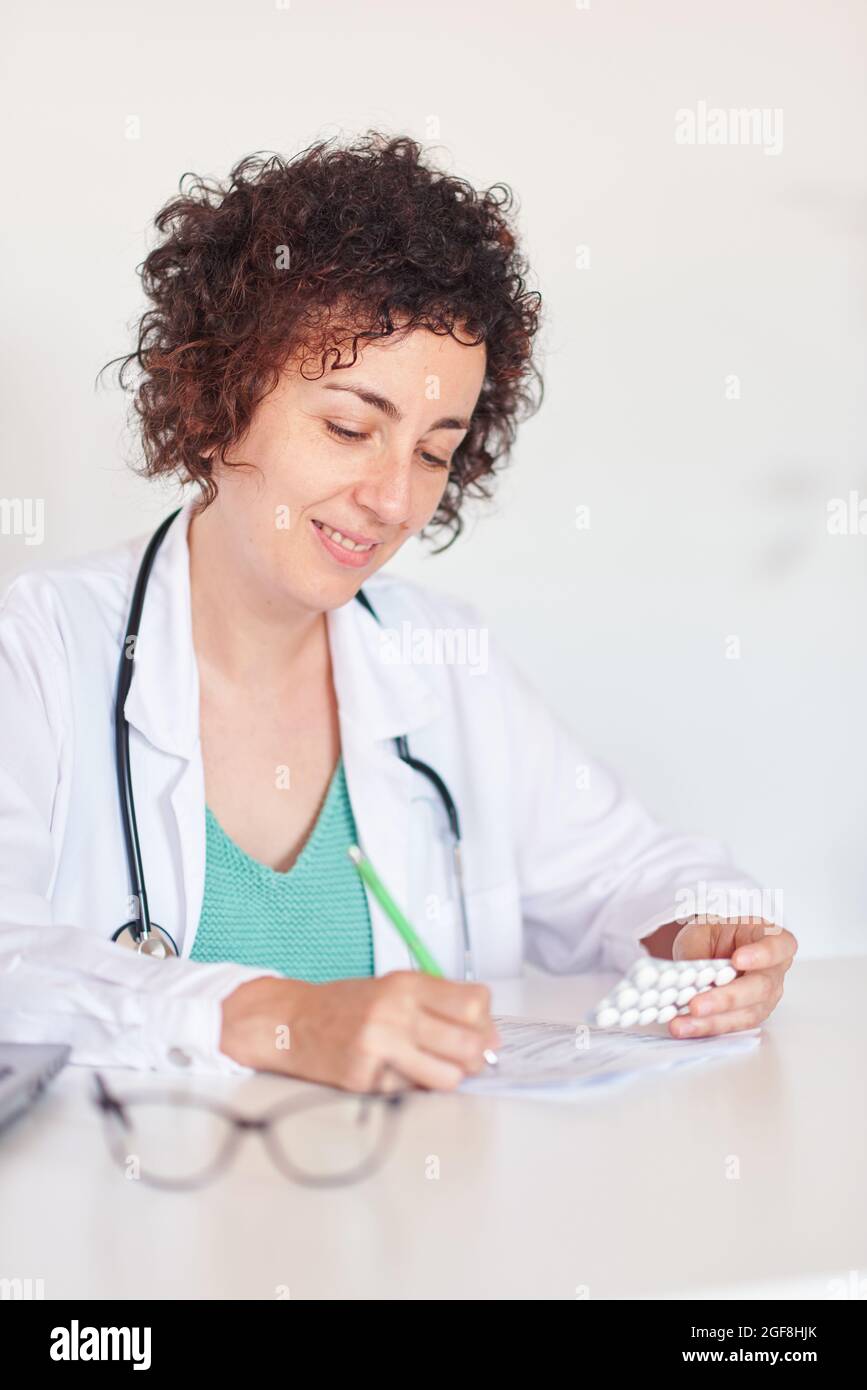 Female doctor writing a prescription Stock Photo - Alamy