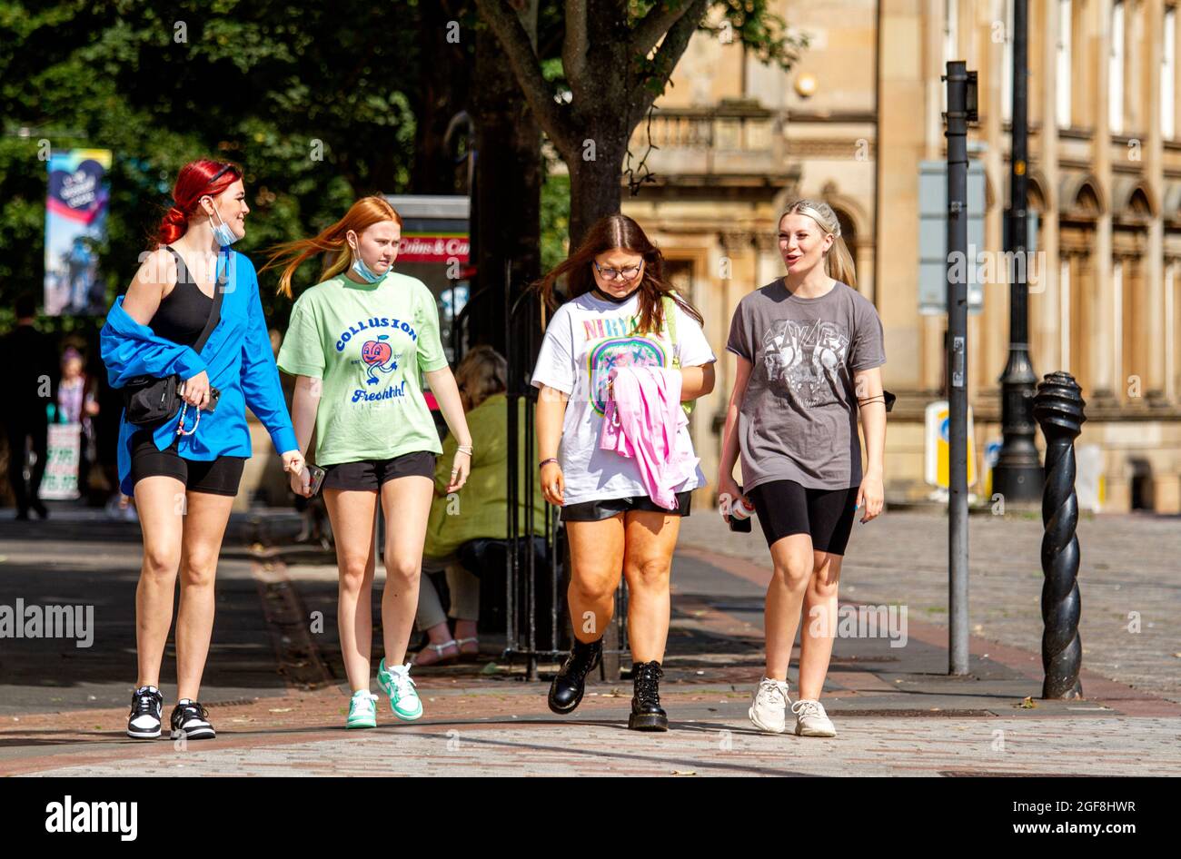 Dundee, Tayside, Scotland, UK. 24th Aug, 2021. UK weather: Glorious warm sunshine across North East Scotland with temperatures reaching 21°C. The late Summer heatwave attracts many local resident to take the day out to enjoy socialising outside after months of Coronavirus lockdowns. four glamorous young women enjoying the weather walking together having fun in Dundee city centre. Credit: Dundee Photographics/Alamy Live News Stock Photo