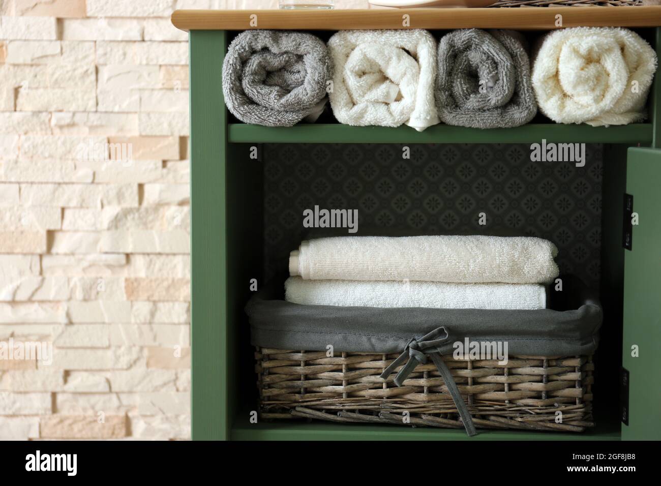Bath towels in wicker basket Stock Photo Alamy