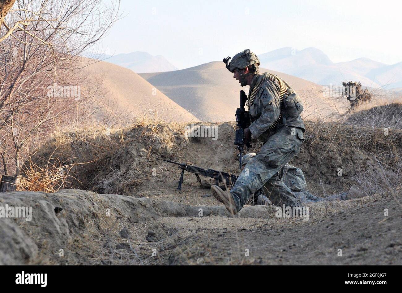 Sgt. Timothy Cooper, a scout with White Platoon, Bulldog Troop, 7th Squadron, 10th Cavalry Regiment, dives from incoming enemy fire during a recon patrol in Bala Murghab district, Badghis province, Afghanistan, Jan. 9. Husk and the other scouts located enemy positions to adjust mortar fire on target. Stock Photo