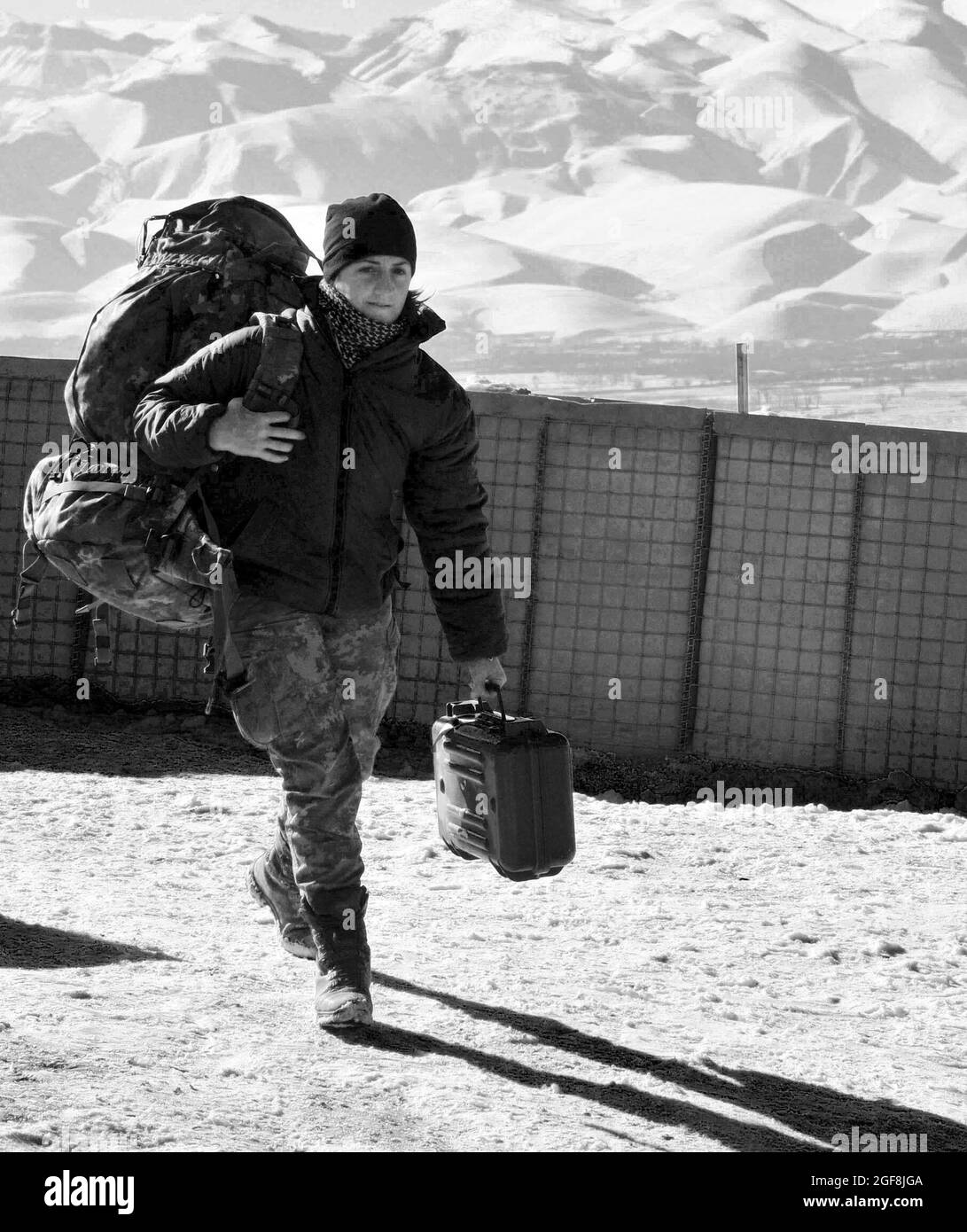 Cpl. Maj. (E-4) Mezzullo Filomena, a mountain soldier from the 6th Company, Tolmezzo Battalion, 8 Alpini Regiment, Julia Brigade, prepares for a convoy from Combat Outpost Sigma to Forward Operating Base Todd, Bala Murghab, Baghdis province, Afghanistan, Jan. 14, 2011. To Filomena, being Alpini means a unity among her brother and sister Alpine soldiers. Stock Photo