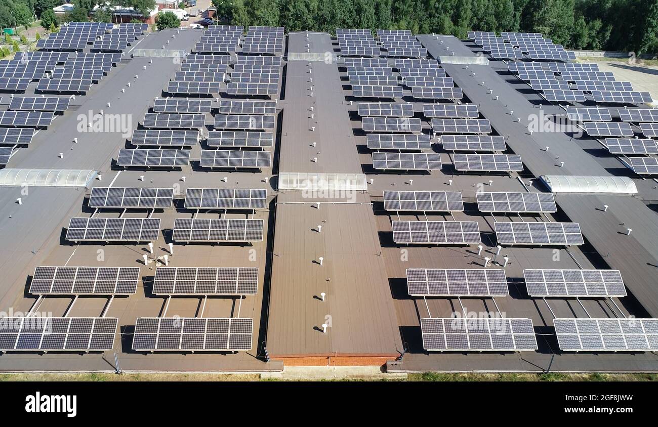 Aerial view of solar energy panels on a roof of a building. Power plant of photovoltaic, solar cell farm power plant. Concept of sustainable resources Stock Photo