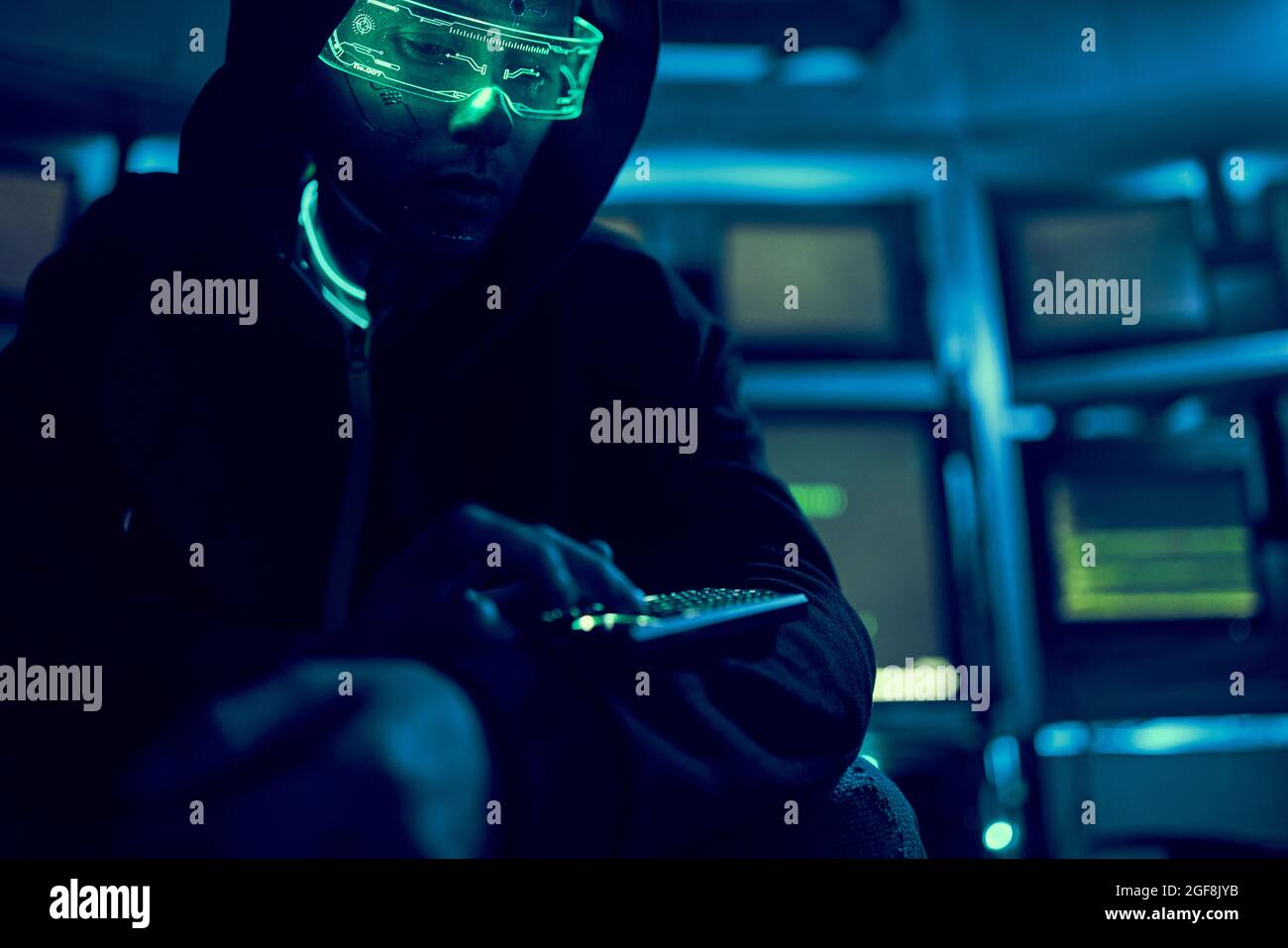 Cyber hacker breaks into databases to obtain information using a computer. Cybercrime and data security concept. Stock Photo