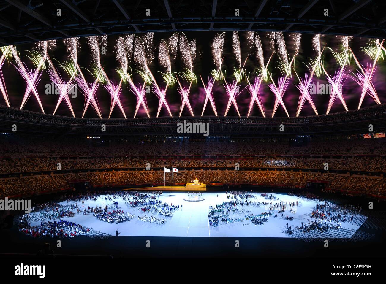 Tokyo, Japan. 24th Aug, 2021. Fireworks explode after the cauldron ...