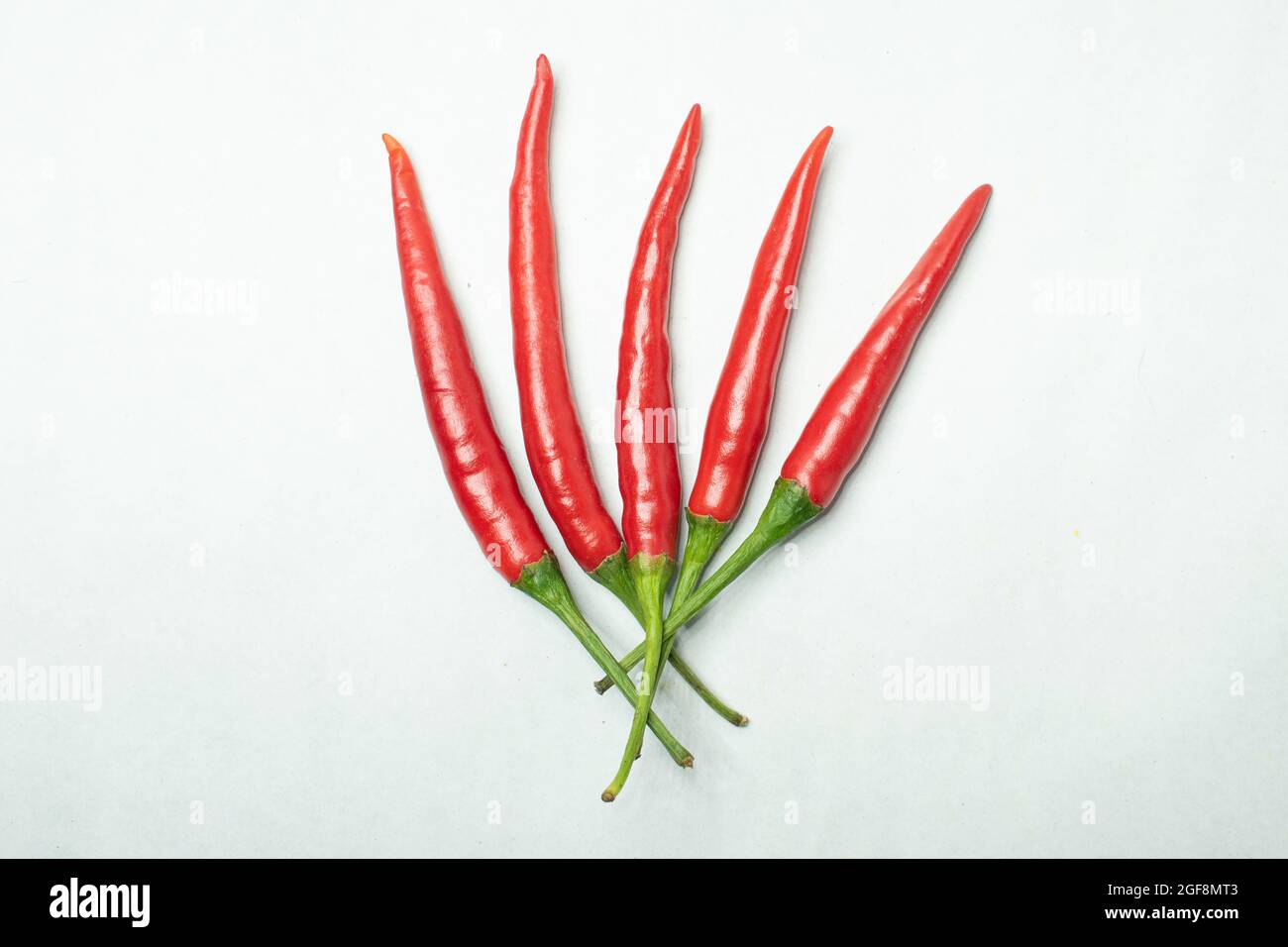 Closeup of red chili peppers on white background Stock Photo - Alamy