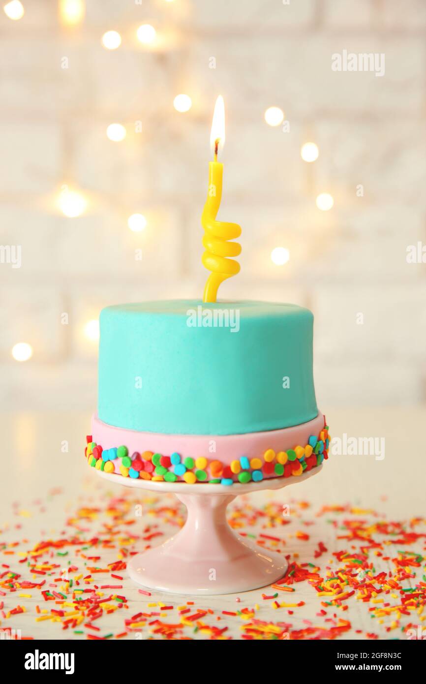 Birthday cake with one candle on white background Stock Photo Alamy
