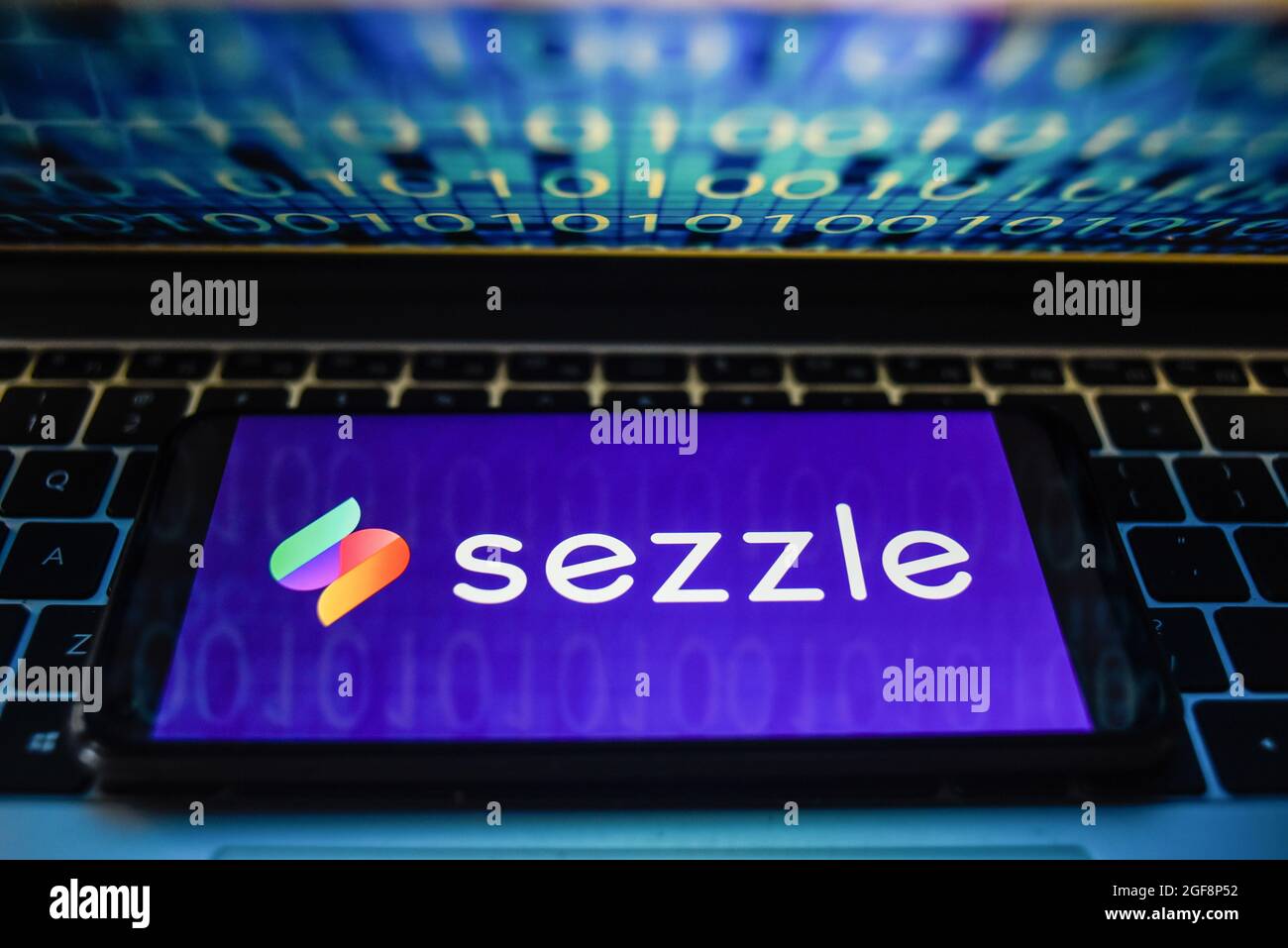 In this photo illustration a Sezzle logo seen displayed on a smartphone