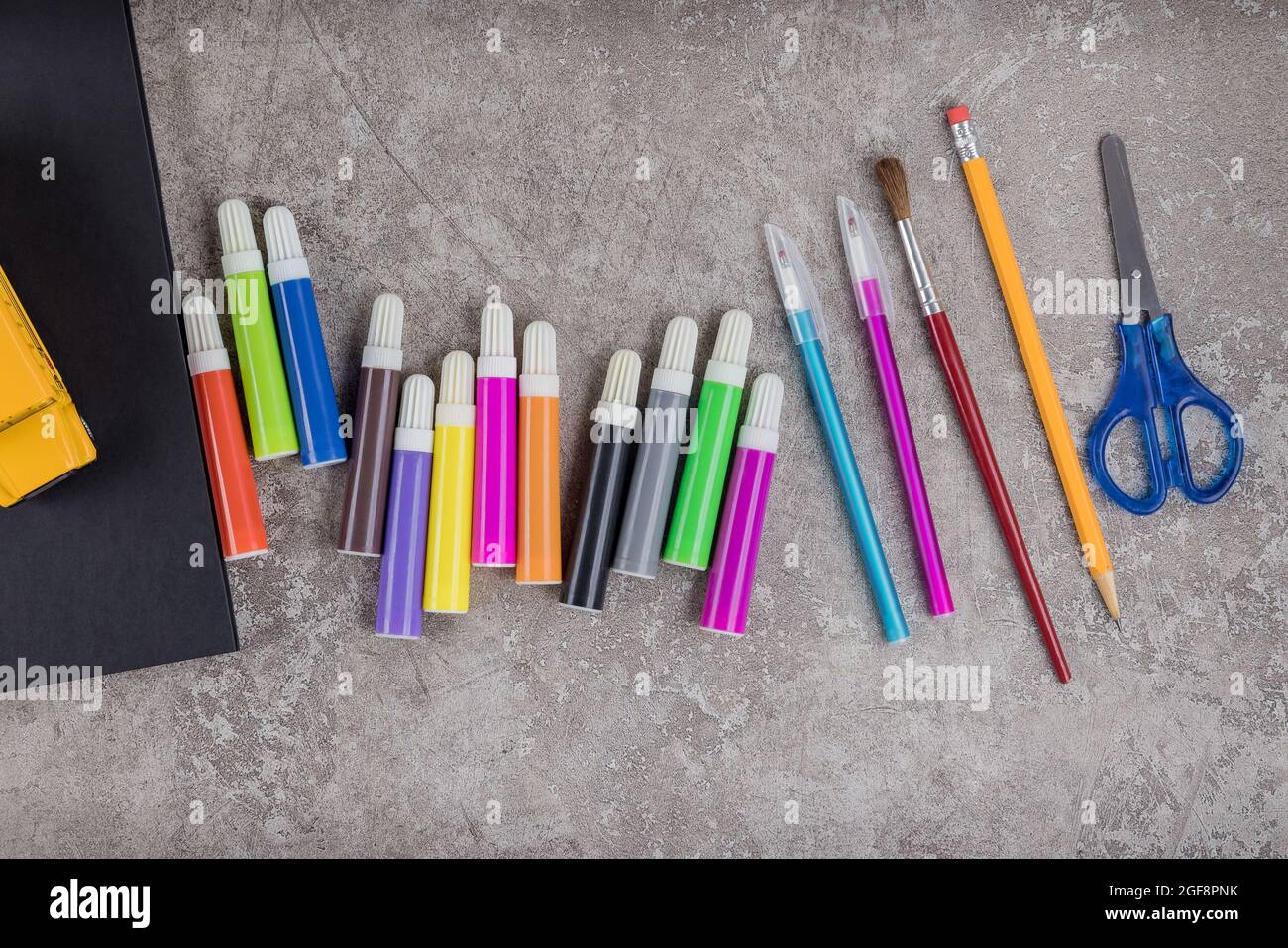 Items for the school on grey surface. Back to school. Stock Photo
