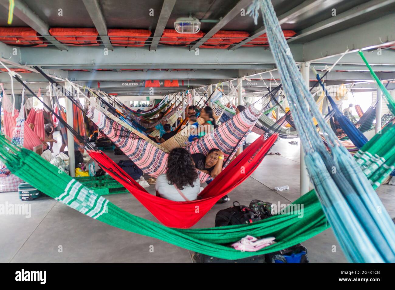 TABATINGA, BRAZIL - JUNE 22, 2015: Passengers of hammock deck at the boat Diamante which plies river Amazon between Tabatinga and Manaus, Brazil. Stock Photo