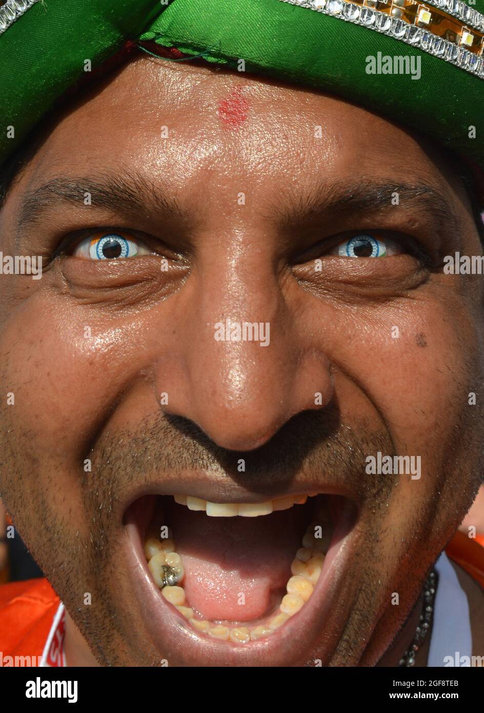 A cricket fan of India wearing a contact lens of the national flag of India One Day International - ODI - England v India 2014 Stock Photo